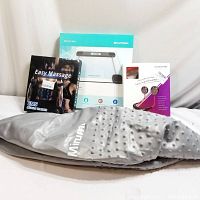 Photo shows all four items together: EMS muscle trainer in black box, Beatural digital scale in white and blue box, pink neckband fan box, and grey Mirumb gym ball in front.