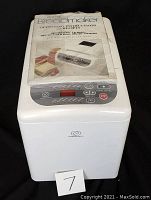 White Charles Craft Deluxe Electronic Breadmaker unit with control panel showing LCD display and buttons.