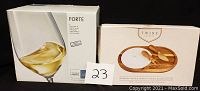 Boxes of Forte wine glasses and Twine Living Co. gourmet wood and ceramic cheese board gift set with cutting tools visible, with lot number 23 in photo