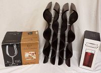 Photo showing 6-bottle wood wine rack with wave shaped sides and metal rods, alongside original boxed set of 6 Cabernet wine glasses.
