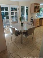Full view of table and six chairs in kitchen area