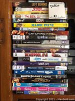 Top view of DVDs and PS3 game stacked horizontally showing titles like Left Behind, Hobbs & Shaw, Deadpool 2, Doctor Who, Finding Nemo