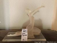 Full view of the frosted glass figurine showing the woman kneeling with arms extended, butterfly on her hand, placed on a rectangular glass base.