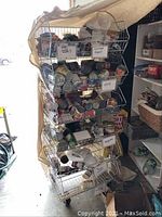Shot of the wire bins stacked with cans to show size and construction, bins are metal wire and mounted on casters.