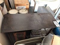 Top view of the wooden cabinet showing worn and scratched dark surface.