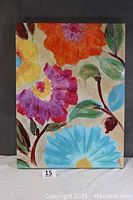 Front view of the colorful floral painting showing thick textured flowers and leaves.