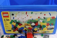Blue Lego storage tote with lid showing set number 4107, indicating 1000 pieces included, suitable for ages 4-99.