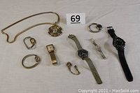 Overview photo showing the full collection of 11 vintage watches and one watch necklace, various styles and sizes displayed on table
