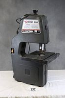 Front view of the black Craftsman motorized bandsaw highlighting its structure and work table.