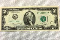 Front side of a 1976 United States two dollar bill showing a portrait of Thomas Jefferson, serial number, and green treasury seal.