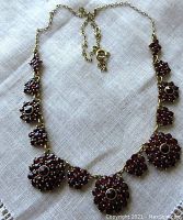 Full necklace laid flat showing chain, clasp, and clusters