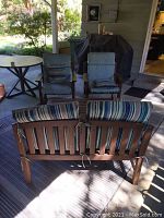 Overall set arrangement with two chairs, loveseat turned away, and table on patio