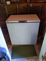 Front view of the white Eaton Viking chest freezer showing stains on the top surface and a sticker on upper left corner.