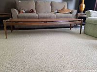 Full front view of the teak coffee table in room setting