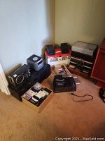 Photo of all items grouped in a corner, including the stereo tape player, speakers, Yorx radio, cassette tapes box, and accessories.