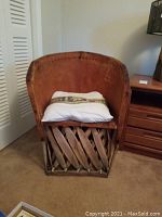 Front view of the leather wrapped wood chair with elephant throw pillow placed on the seat.