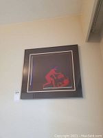 Full view of framed art print hanging on a wall