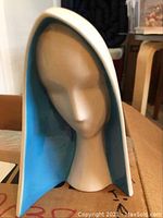 Modern minimalist Virgin Mary bust figurine with blue and white hood shown from front