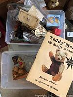 Two small tubs with a variety of miniature teddy bears in different materials and a 1996 collectors guidebook.