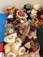 Overview of numerous collectible plush bears in a tub, showing variety of brands and accessories including Bearington, Hallmark, Pouzelli, Chelsea.