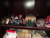 Shelf with various collectible bear figurines including bears on motorcycles and boxed PenniBears.