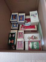 Box containing numerous Hallmark Keepsake ornaments, mostly bears, some in original packaging