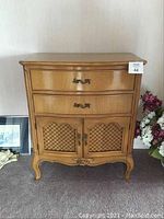 Front view of cabinet showing two drawers and lattice-panel doors