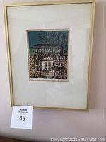 Framed woodcut print mounted on wall with lot number card