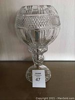 Crystal lamp unlit showing full shape and intricate cut crystal design on globe and base.