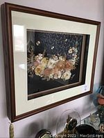 Front view of the framed shell artwork by Yong showing shell arrangement and frame.