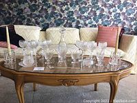Full set on coffee table including decanter, wine glasses, coupe glasses, candle holders