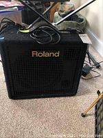 Front of amplifier showing black cabinet, grille and Roland logo