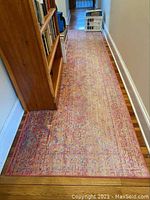 Full length view of Safavieh runner rug in hallway showing faded pattern and wear