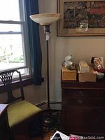 Full view of the tall floor lamp next to window and furniture