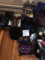 Photo showing a variety of handbags including formal beaded bags, animal print, velvet, and leather shoes in boxes nearby