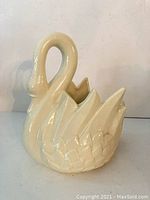Front view of the cream-colored Royal Haeger swan figurine showing detailed wing texture and curved neck.