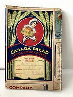 Front view of the worn Canada Bread BeeHive Girls school book cover showing the decorative artwork and name section filled in.