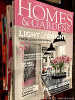 Front cover of a Homes & Gardens magazine with pink and white design, bright and fresh interior decor theme focusing on spring looks and fabric specials.