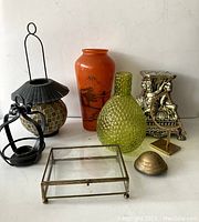 Photo showing 8 decorative items including vases, candle holders, a figurine, a trinket box, and a glass display box.