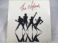 Front cover of The Nylons 'One Size Fits All' vinyl LP showing the album title and stylized silhouettes of four figures.