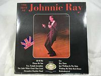 Front cover of 'The Best of Johnnie Ray' vinyl LP with photo of a man singing and British flag icon.
