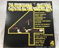 Front cover of the vinyl record showing the title, image of Mantovani conducting orchestra, and track listings on side one and two.