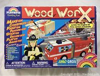 Front box cover showing Playrific Woodworx Jumbo Fire Engine Kit with painted fire truck and firefighter figure illustration, list of contents.