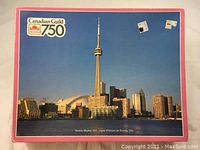 Box front showing the puzzle image of Toronto skyline with CN Tower and water in front under blue sky