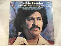 Front cover of Freddy Fender 'Before The Next Teardrop Falls' vinyl LP album showing artist photo and title.