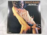 Front cover of 'Disco Baby' vinyl record album showing a woman in an orange fringe outfit