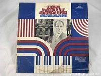 Front cover of the Gershwin Rhapsody In Blue An American In Paris vinyl LP showing graphic design and text.