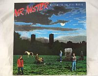 Front cover of Mr. Mister's 'Welcome To The Real World' vinyl LP showing landscape artwork with band members and city skyline
