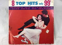 Front cover of the vinyl album showing title '8 Top Hits' and image of dancing couple with red background.