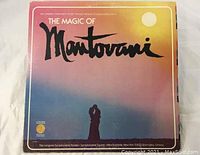 Vinyl LP album front cover titled 'The Magic Of Mantovani' with sunset background and silhouette of a couple.